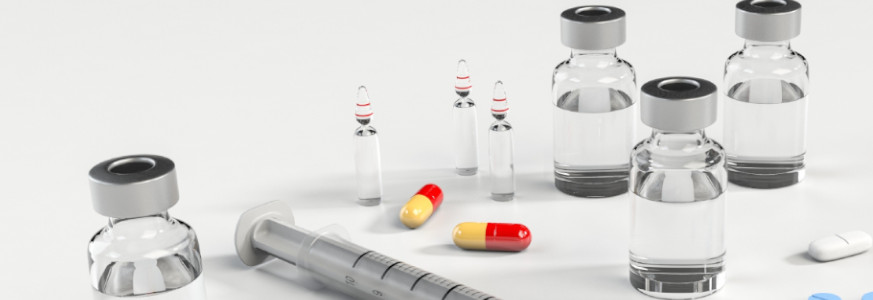 Dangers of Anti-Biotic Resistance Medical supplies, ampoules, syringe, and assorted pills on a white table